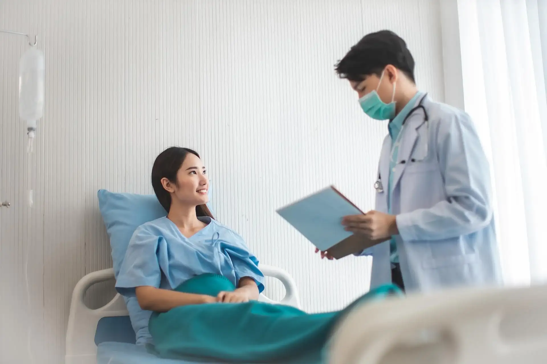 Doctor reviewing a patient's chart during a hospital consultation at Amen Family Medicine in Livonia, MI