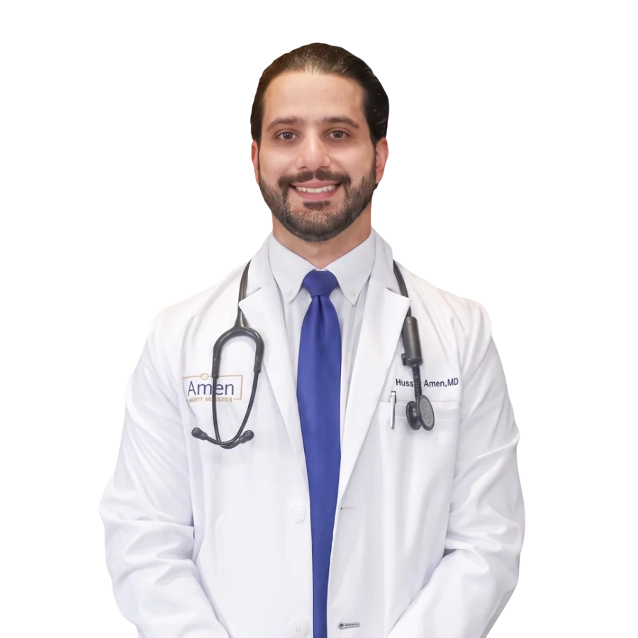 Dr. Hussen Amen, MD, board-certified family medicine physician standing in front of the Amen Family Medicine